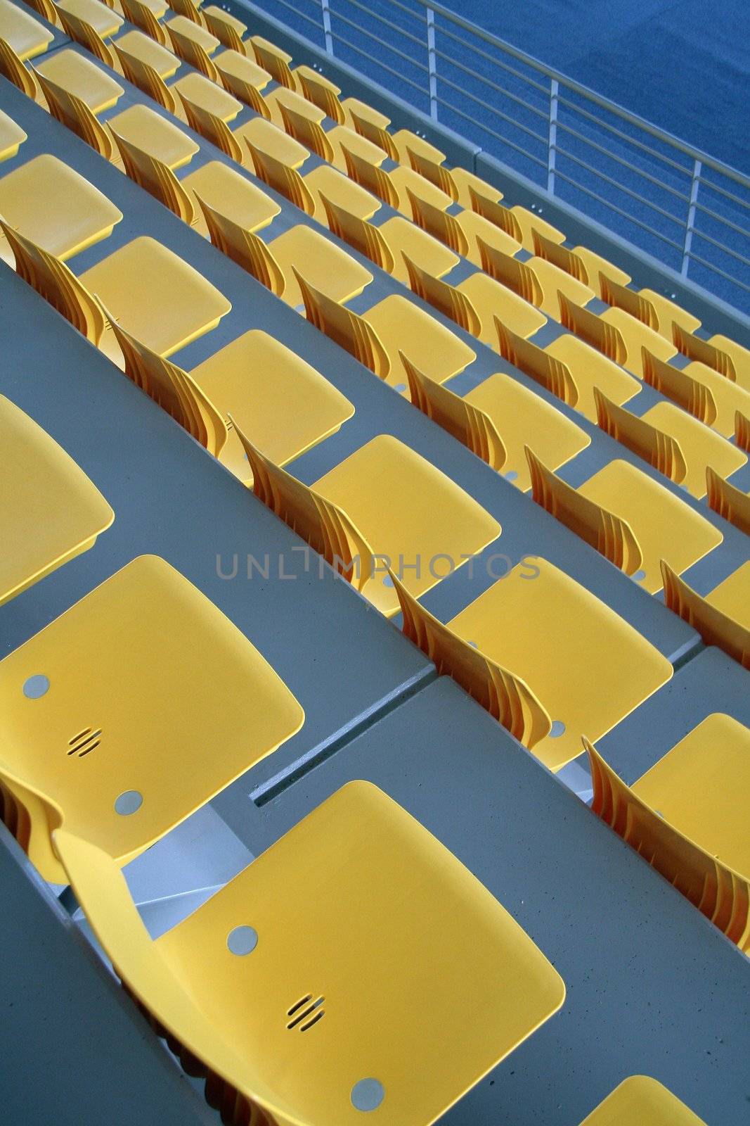 empty yellow stadium seats, grey concrete, part of sport hall