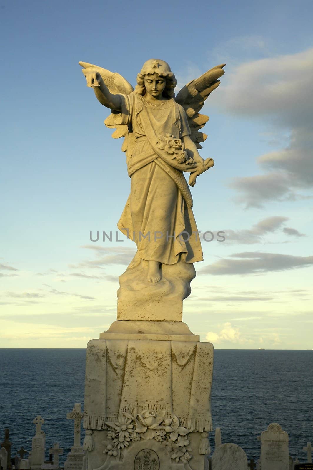 angel sculpture in sydney coast, ocean in background