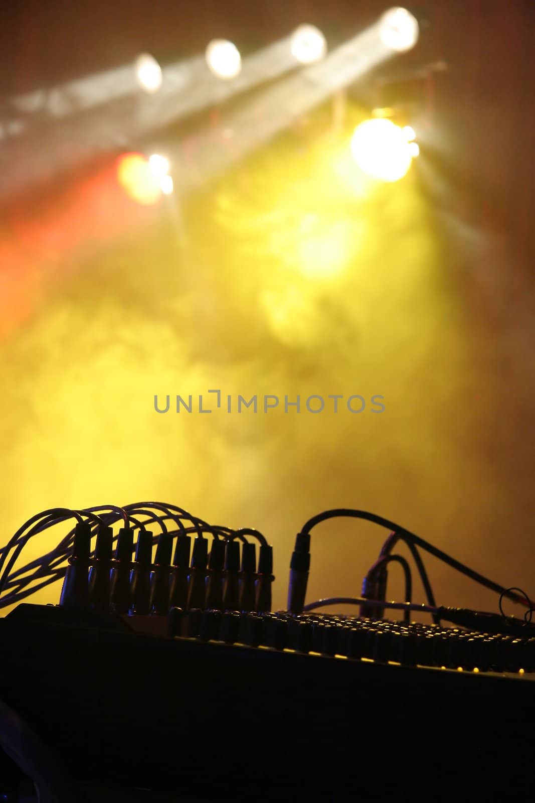 silhouette of music instrument during a concert, lights and fog in background, simple photo