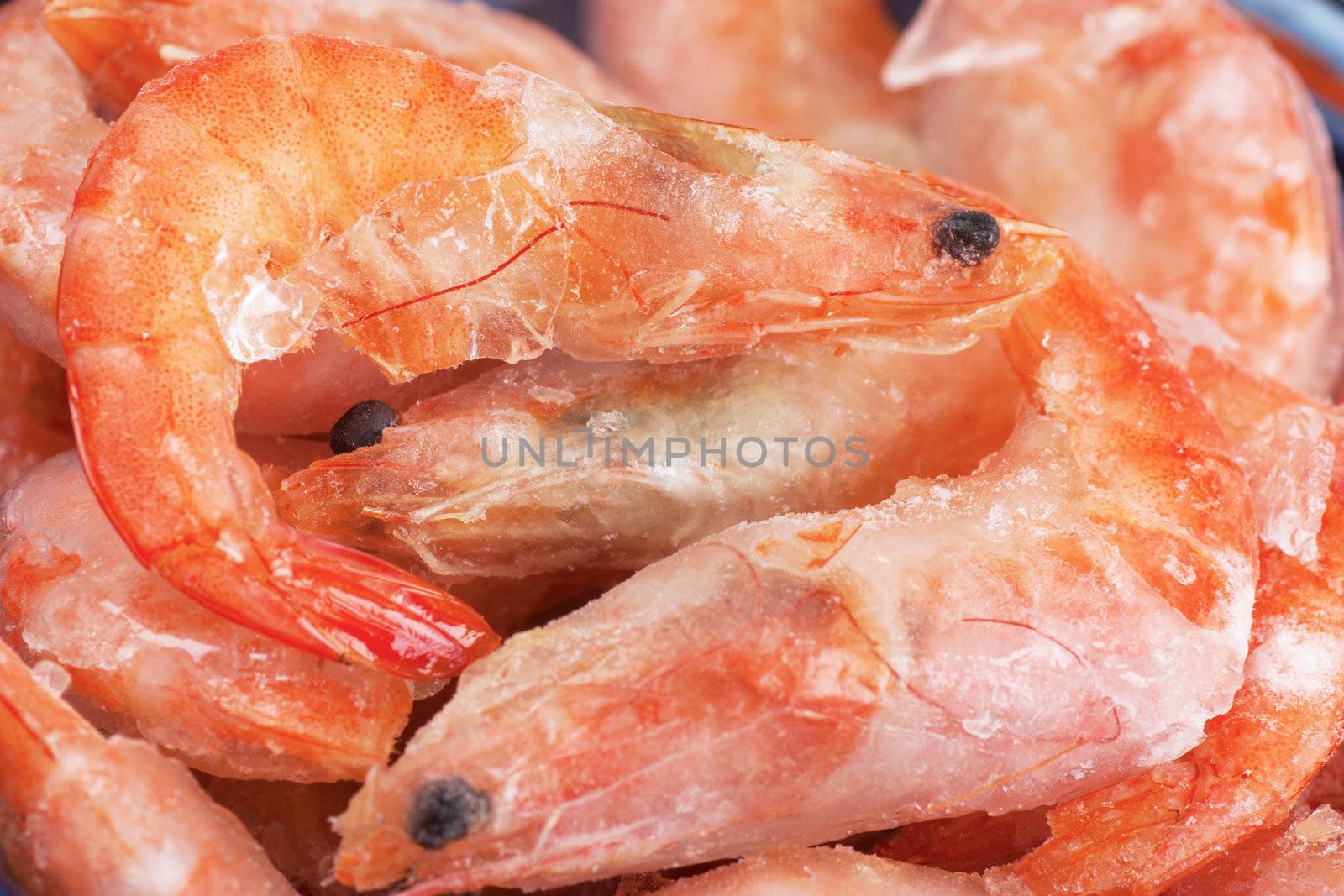 Closeup view of a heap of frozen shrimps