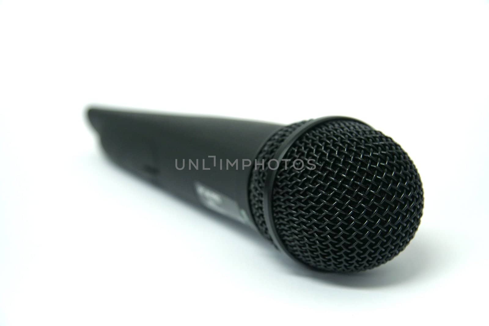 black wireless microphone isolated on white background, distance blur