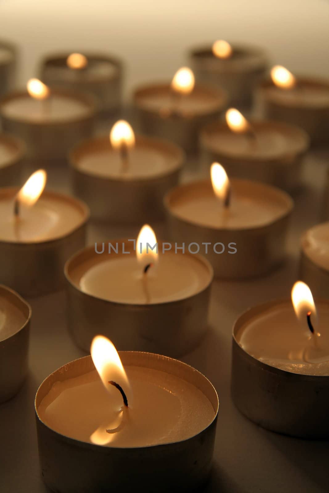 several burning candles, distance blur, brown color