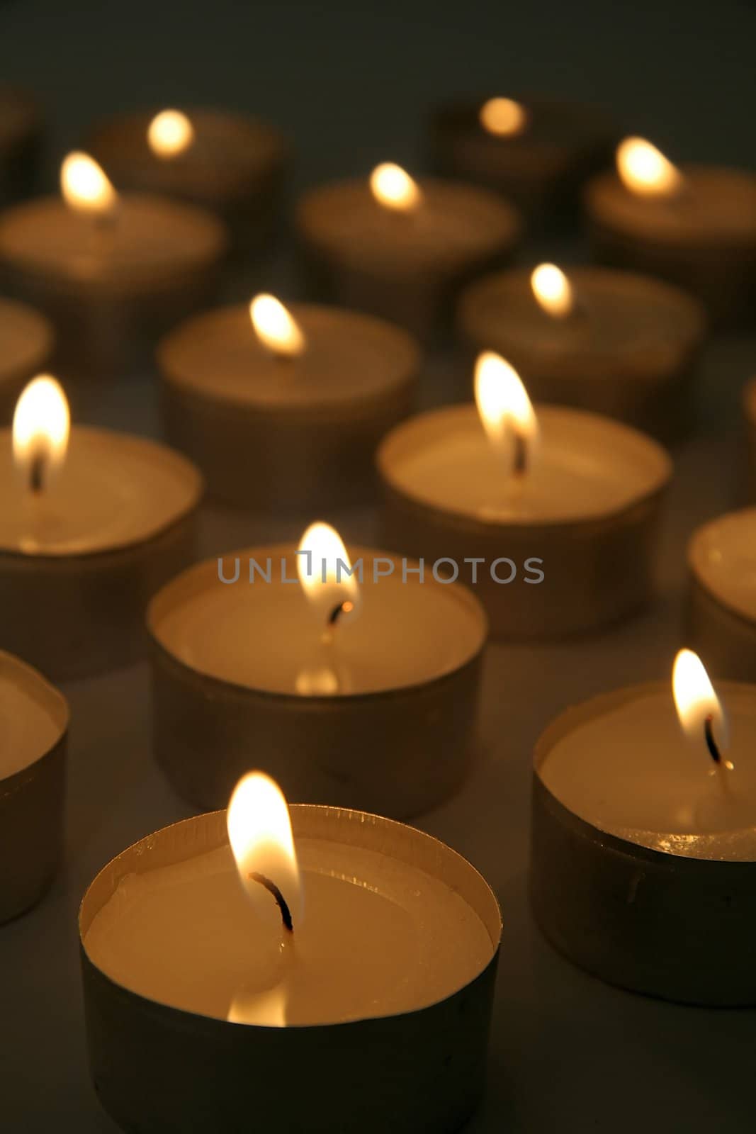 several burning candles, distance blur, brown color