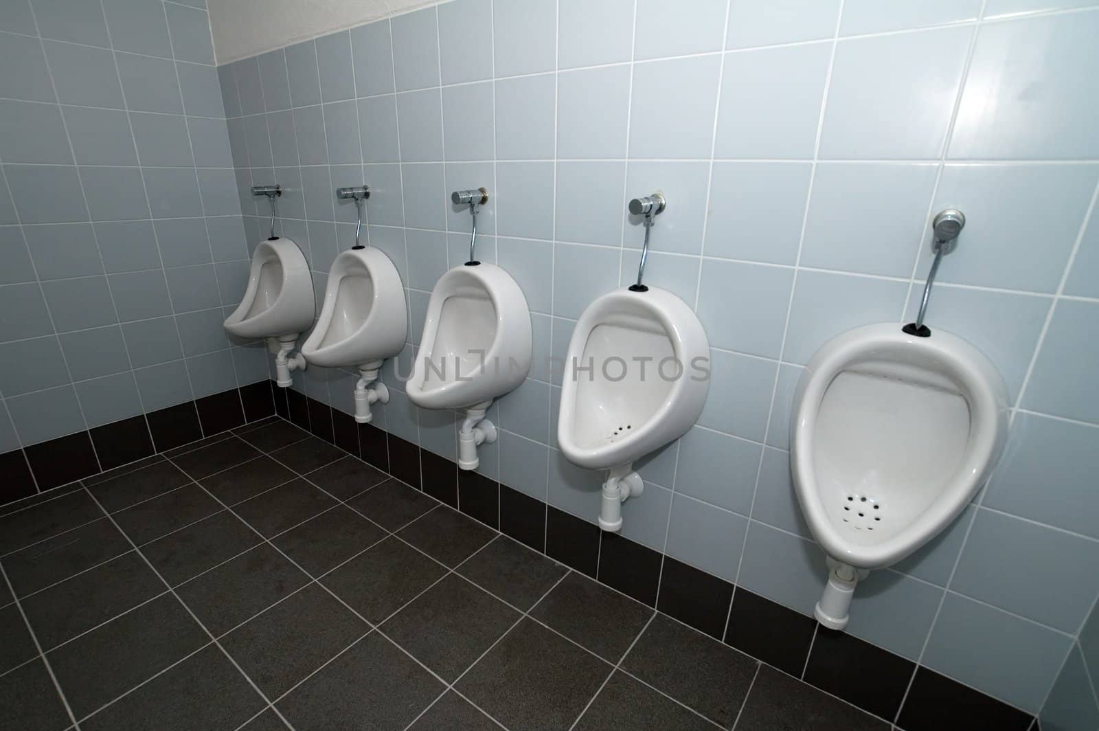 four pissoirs in titled public bathroom