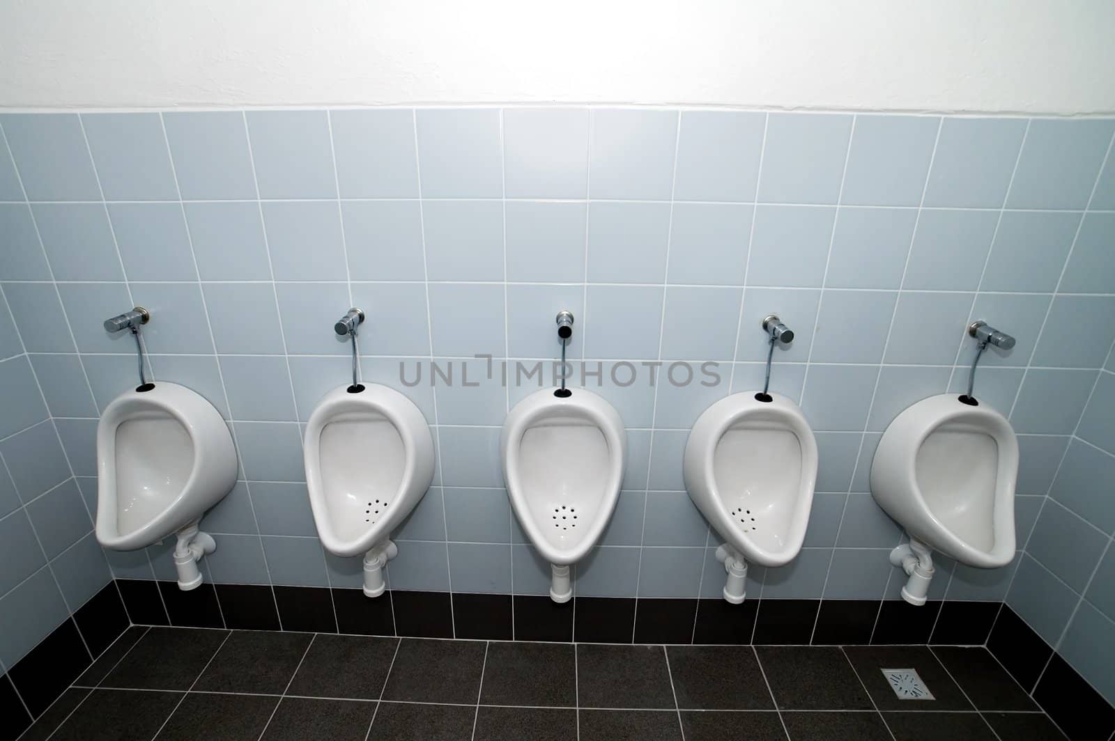 four pissoirs in titled public bathroom