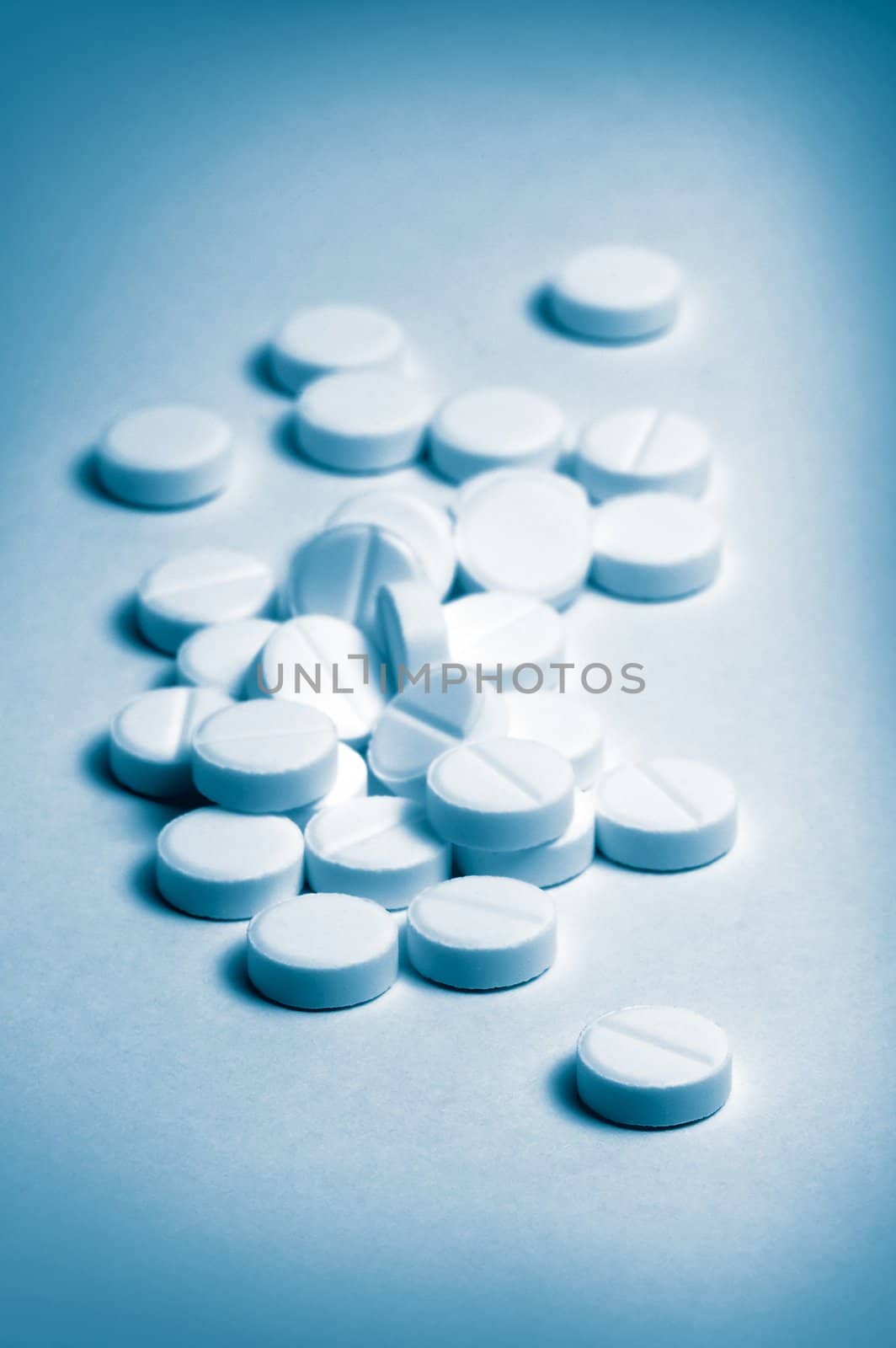 several pills, distance blur, cyan and white color