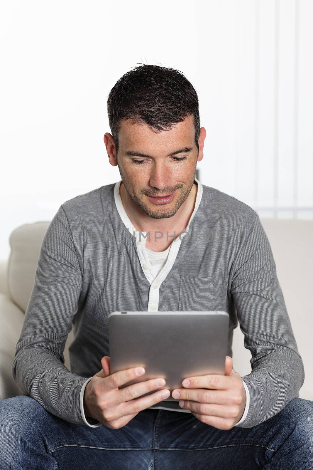 young man on sofa with a digital tablet