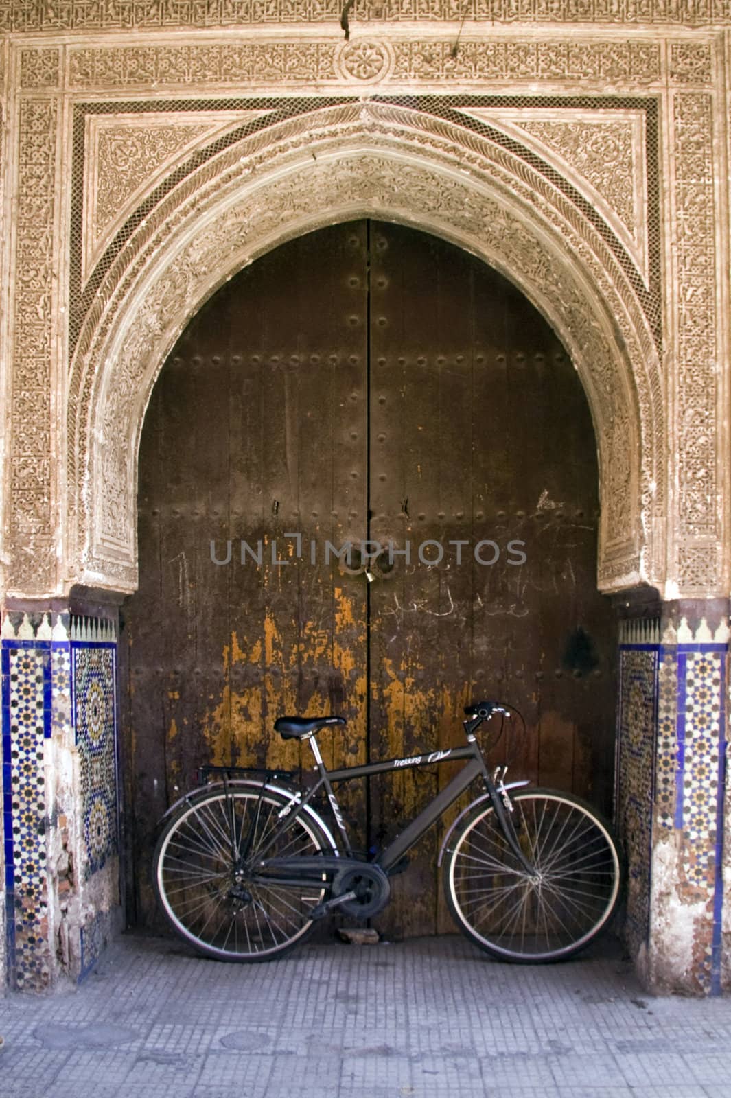 Bicycle leaning against door in archway