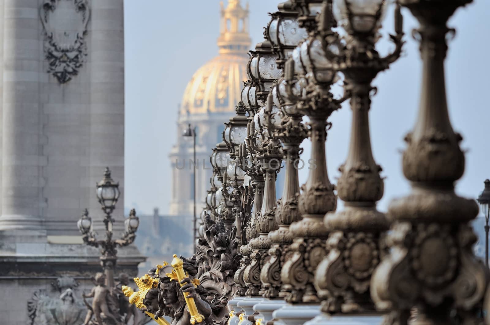 Lampposts on the bridge and the golden Dome of the Cathedral