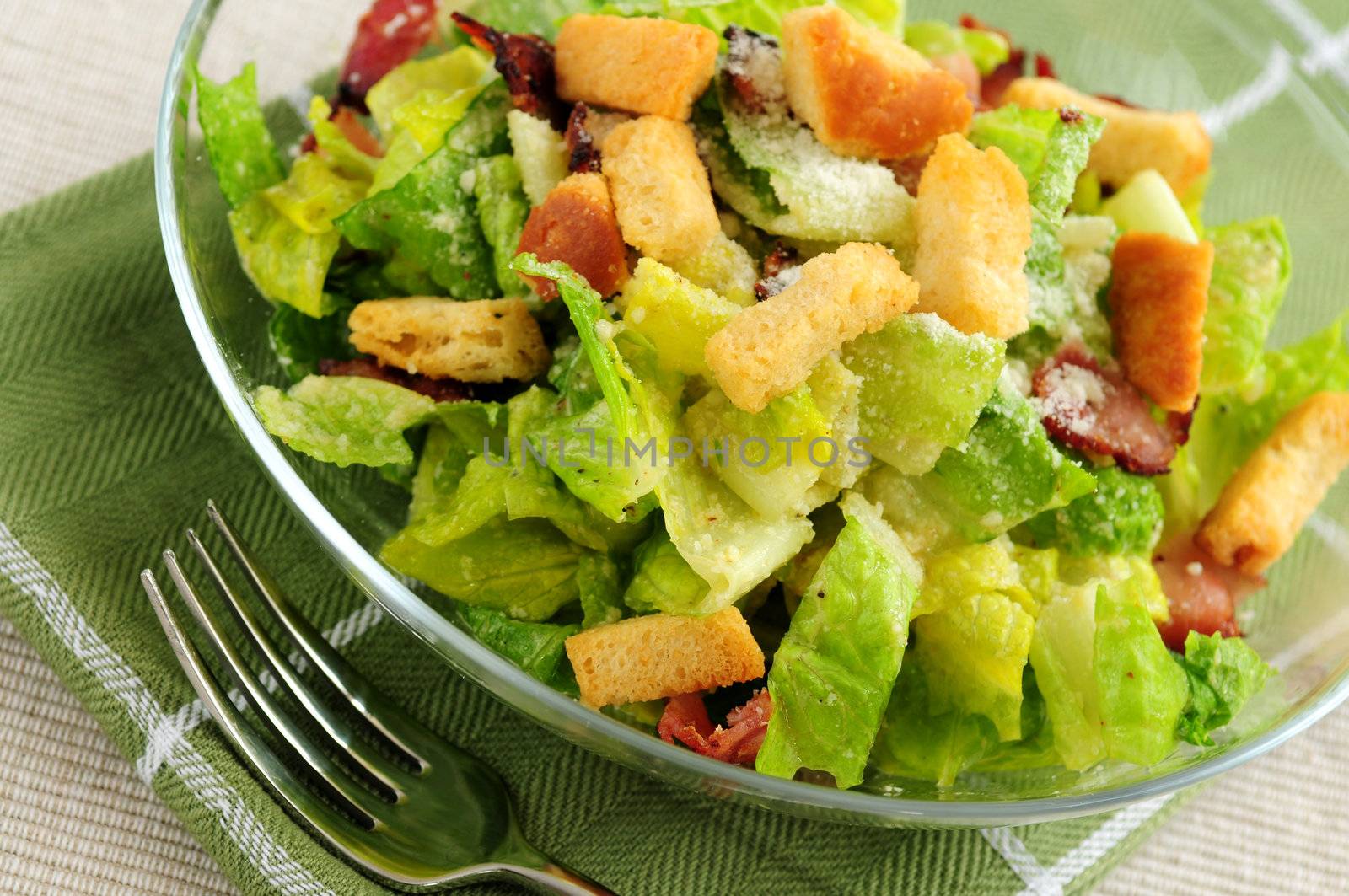 Fresh caesar salad served in a glass bowl