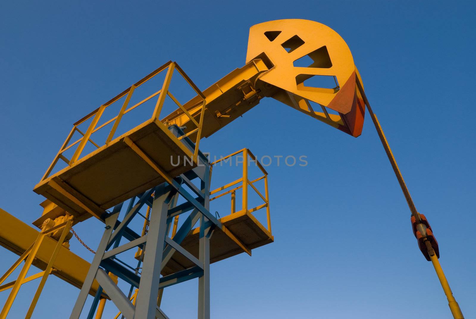 Oil pumpjack against blue sky