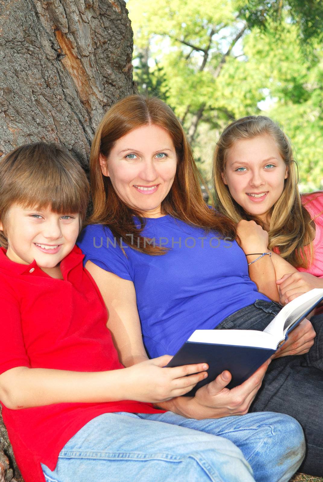 Family reading a book by elenathewise