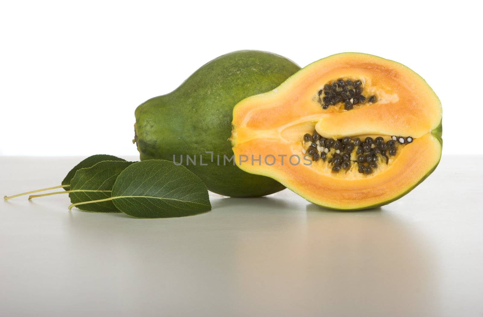 Picture of a papaya over a white table