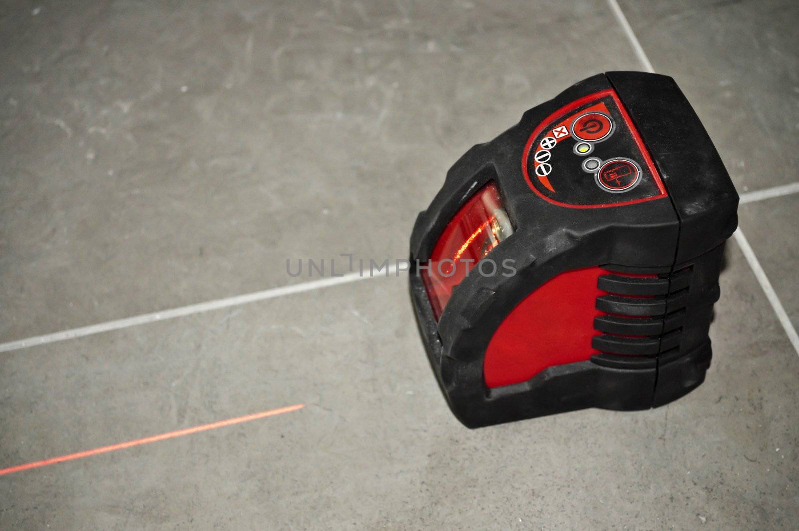 laser level tool with laser beam black on floor