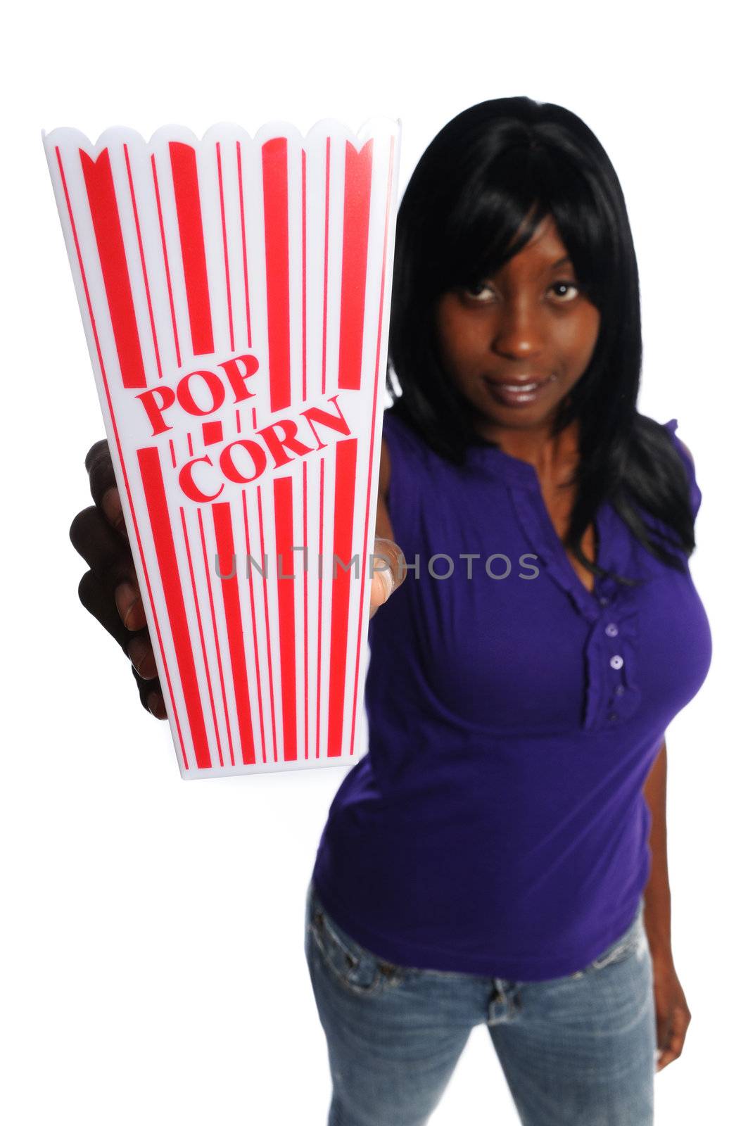 attractive african-american woman holding a container of popcorn on a white background
