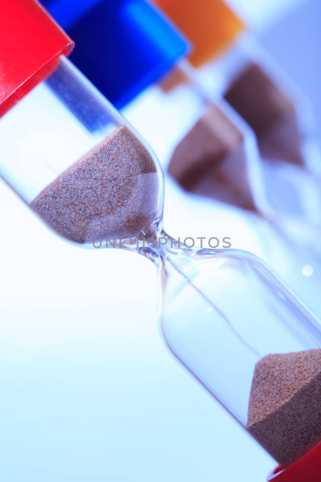 Extreme closeup of few hourglasses on white background