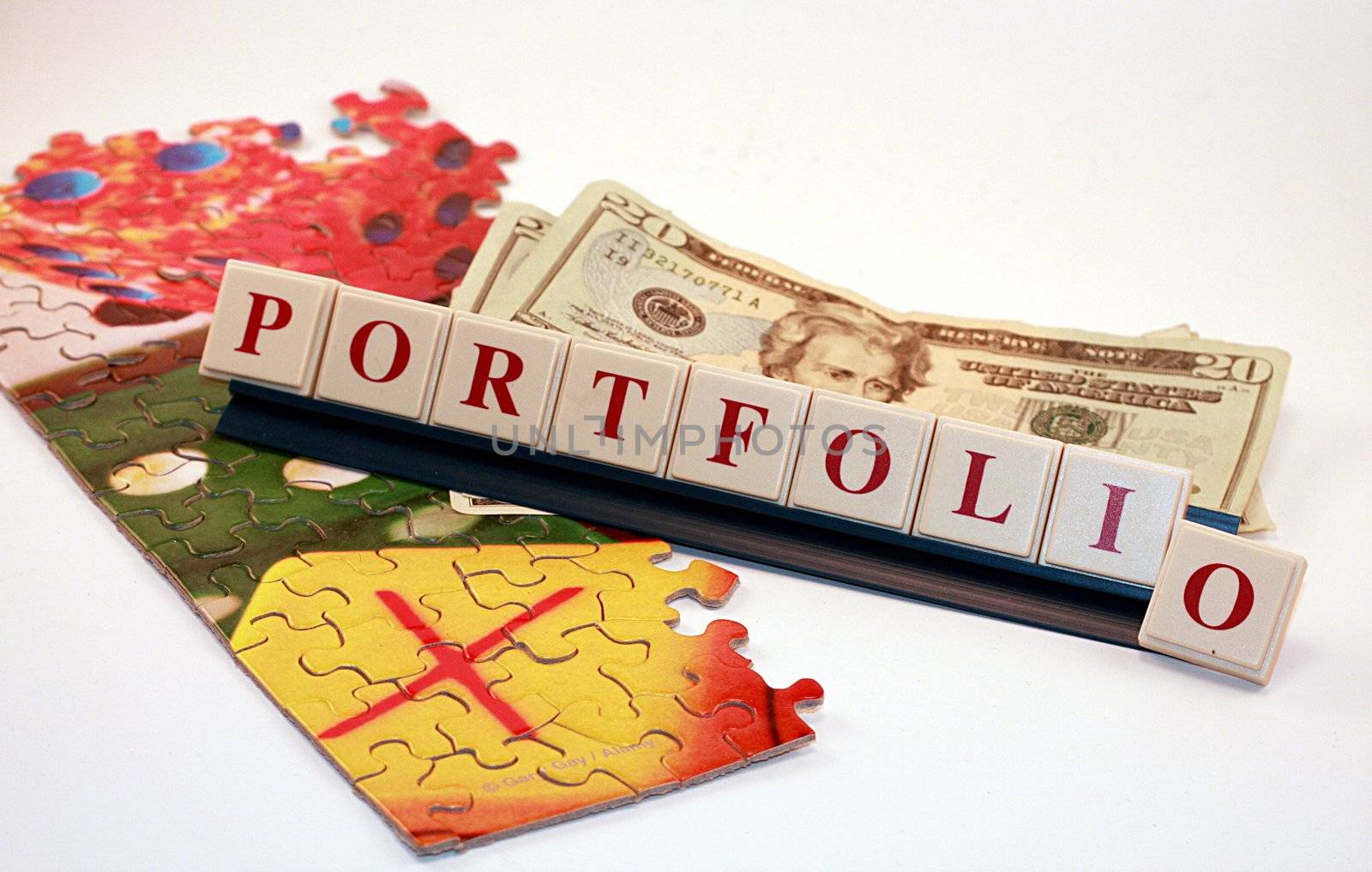 Financial Portfolio with Money and Puzzle Pieces by knktucker