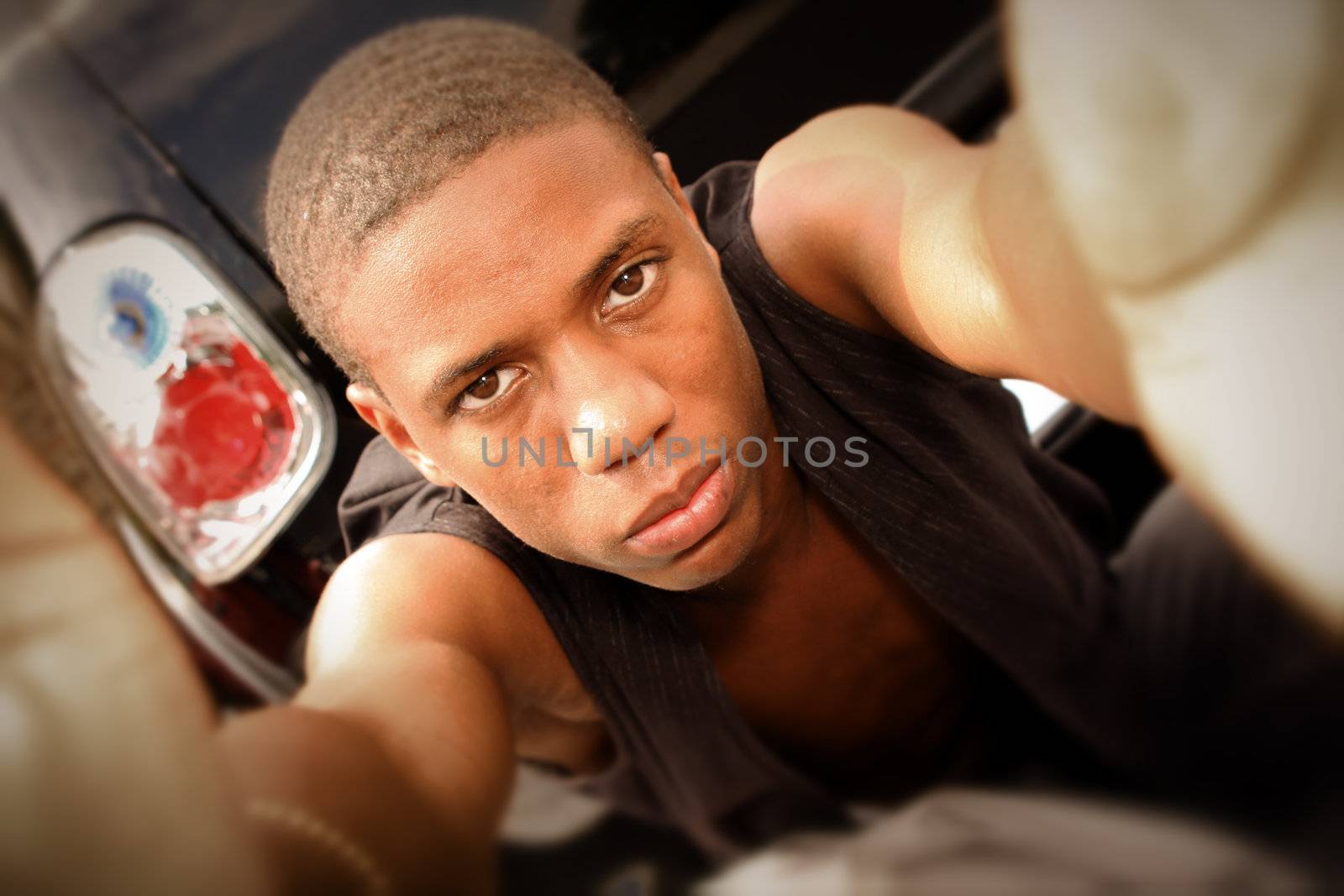 an african american man reaching for the camera, looking tough