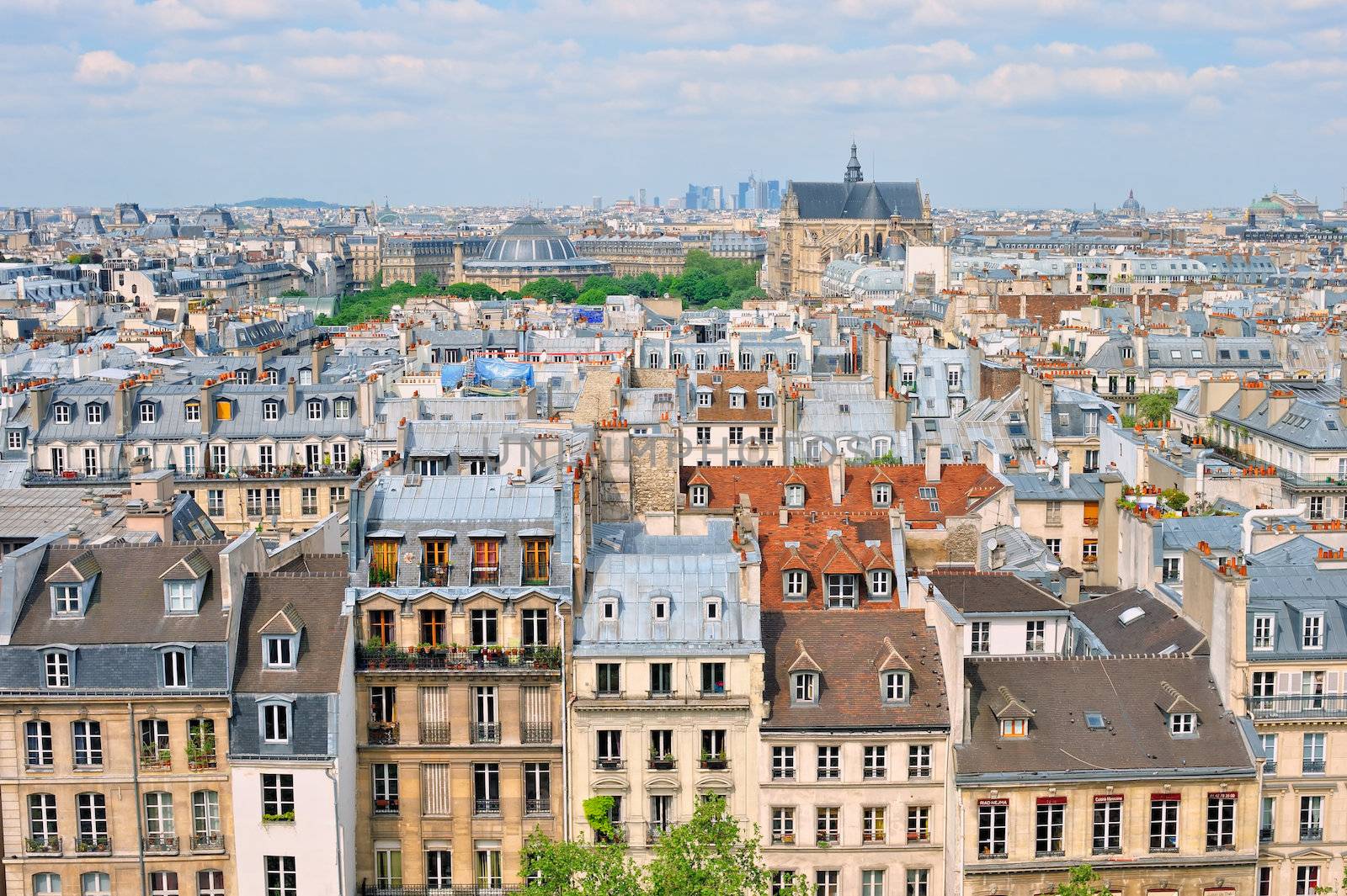Aerial panorama above houses rooftops in a Paris