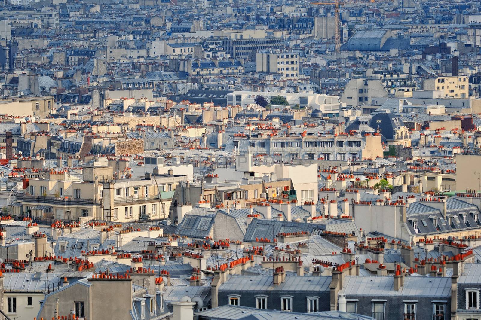 Aerial panorama above houses rooftops in a Paris