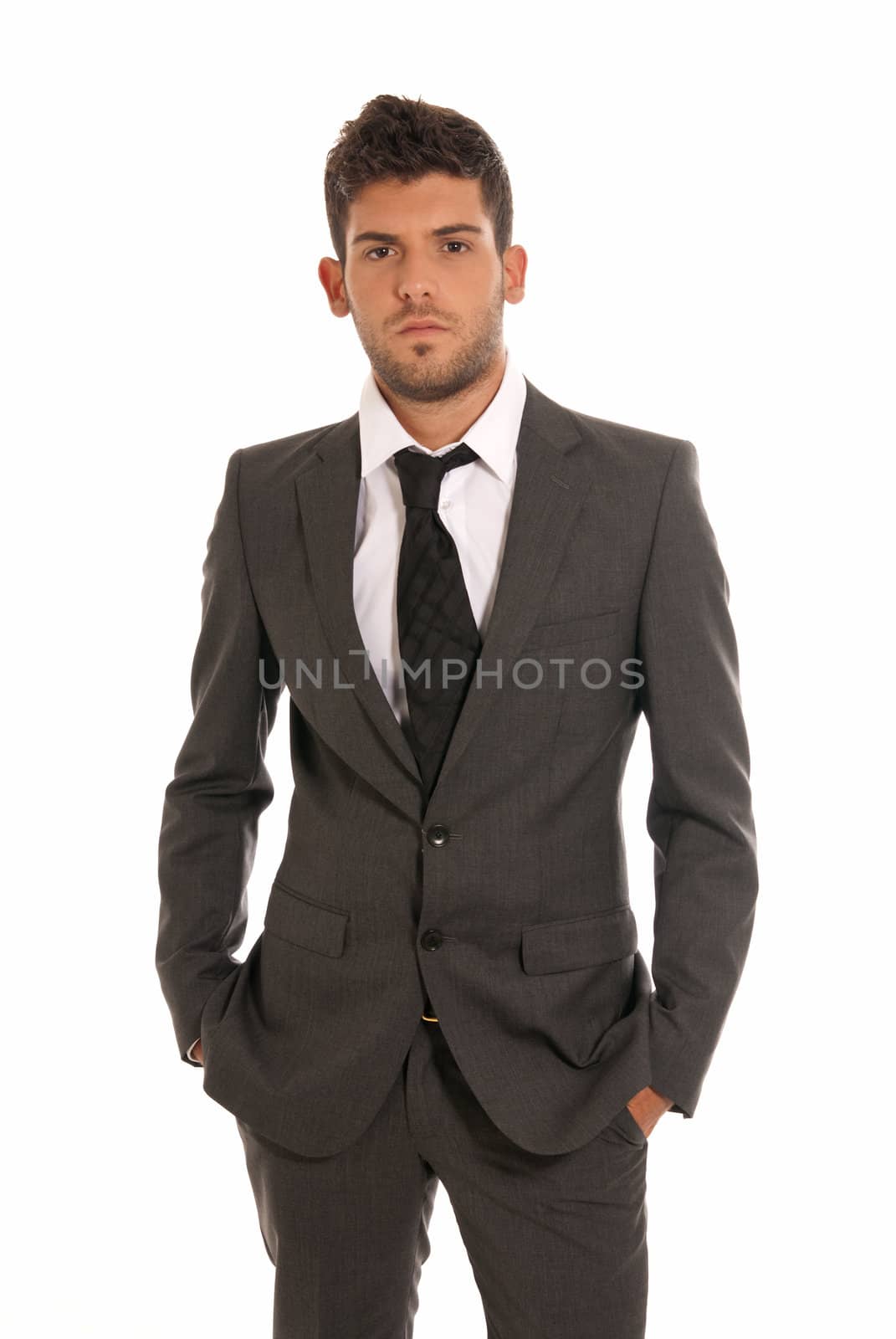 Young businessman looking serious hands in pockets isolated on white background