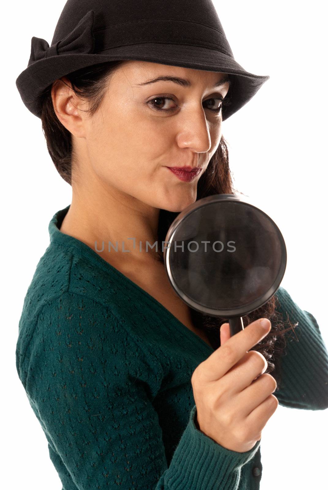 young woman with magnifier glass and hat looking to camera isolated on white background