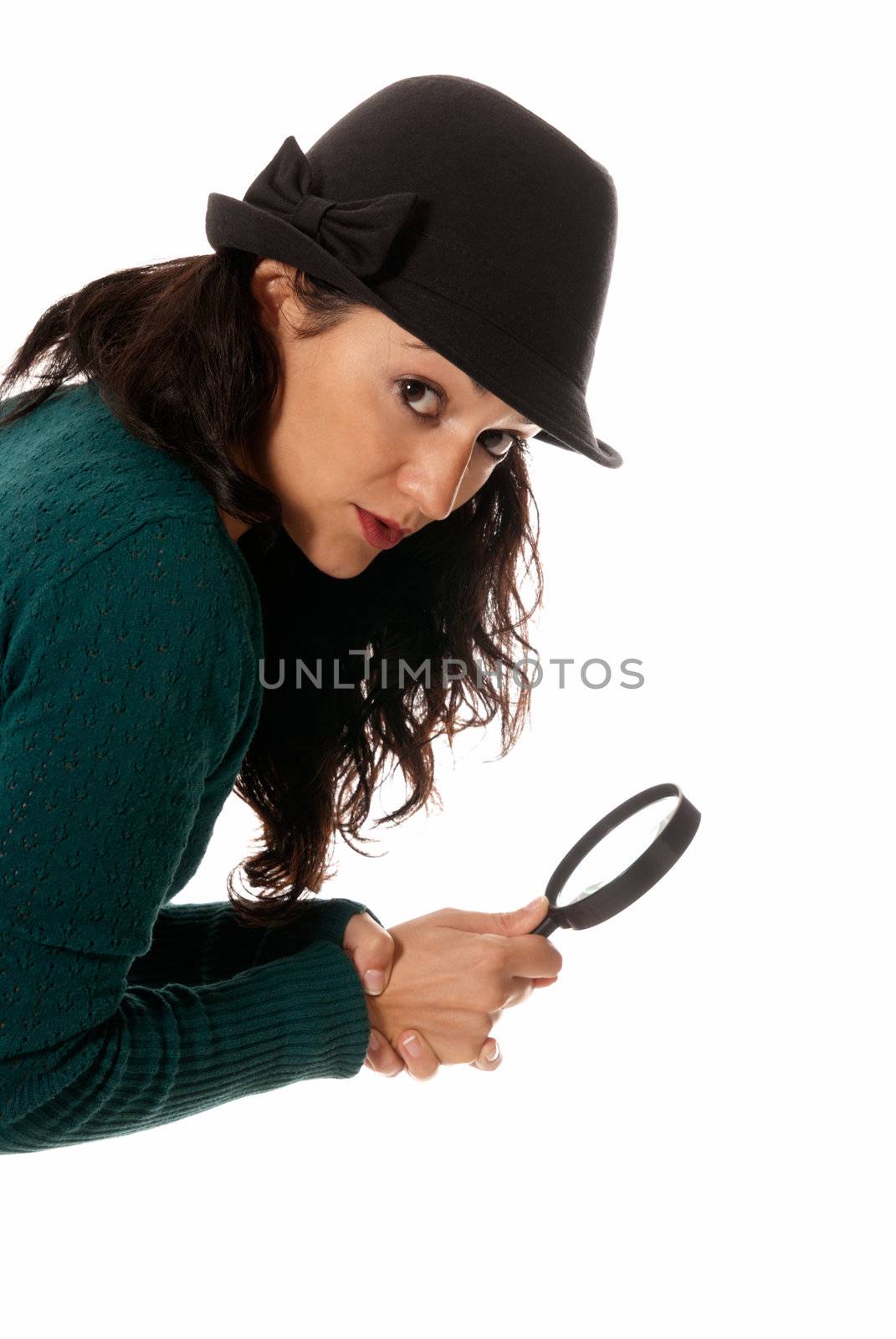 young woman with magnifier glass and hat looking to camera isolated on white background