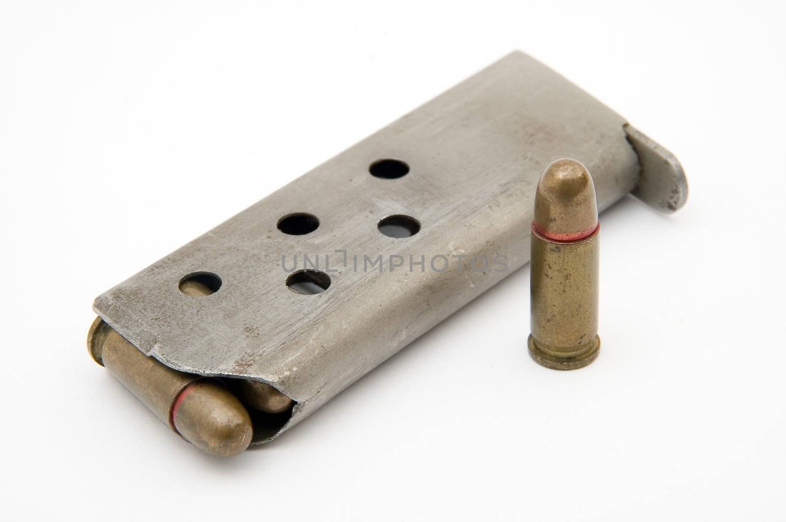 ammunition magazine and a single bullet isolated on white background