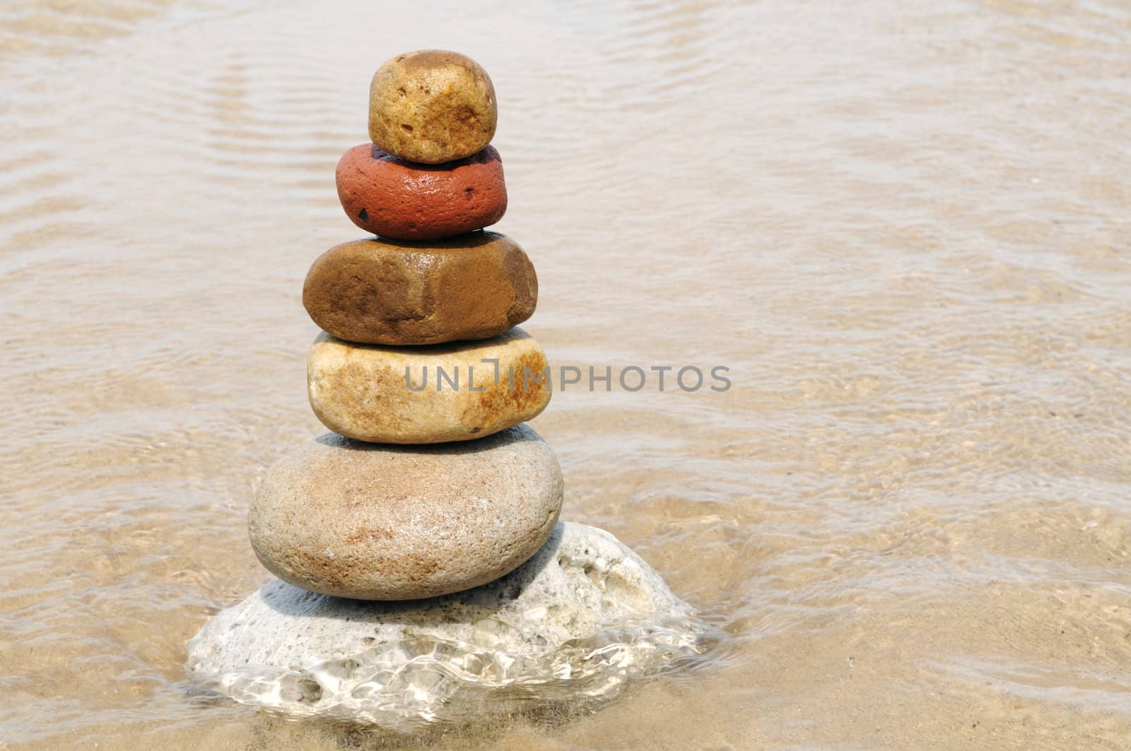 Stacking of pebbles on the seashore.