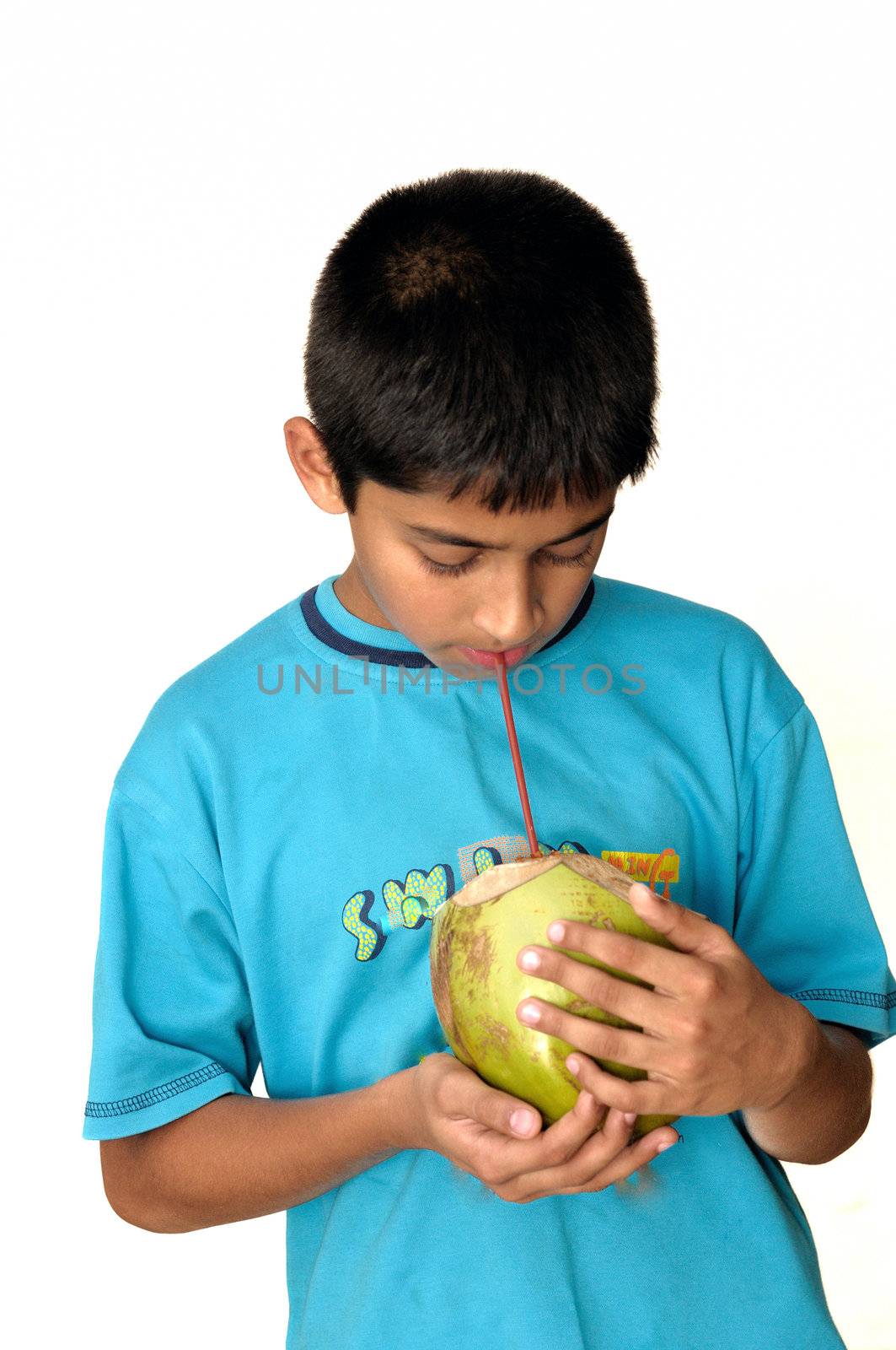 An handsome Indian kid drinking coconut water to cool off 