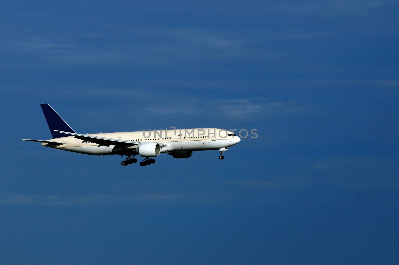 An aeroplane with landing gears switched on and ready to land