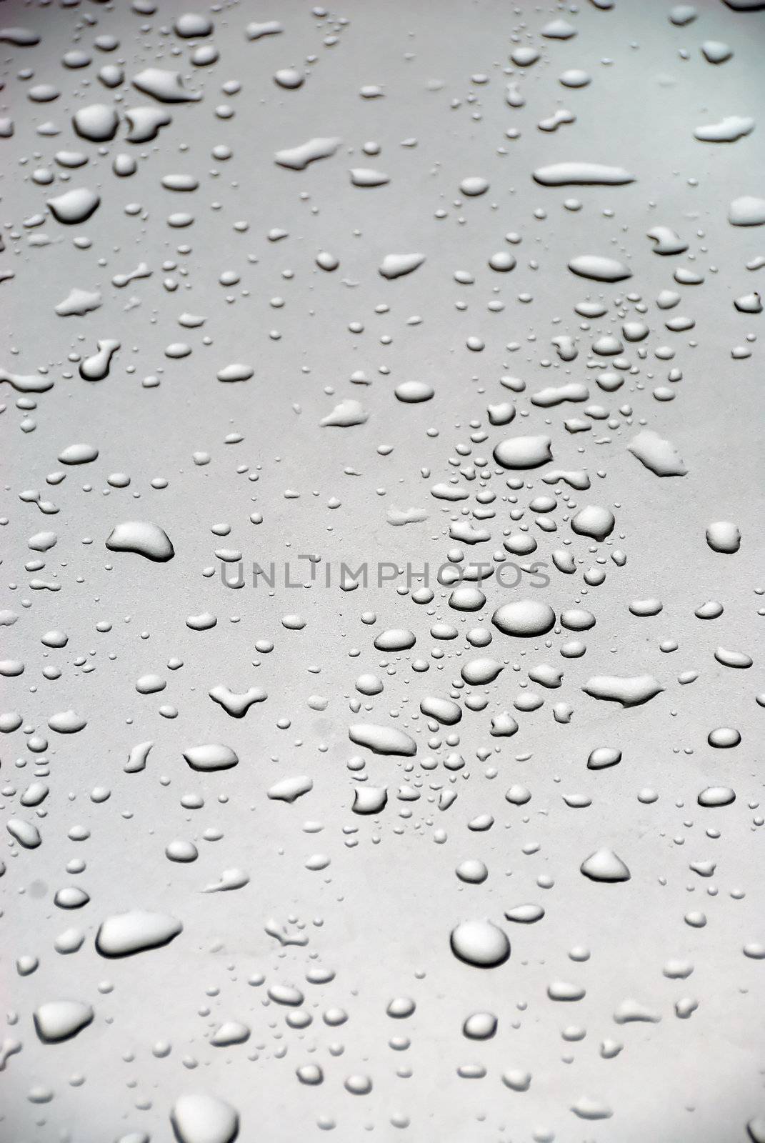 Rain drops on the glass of a car