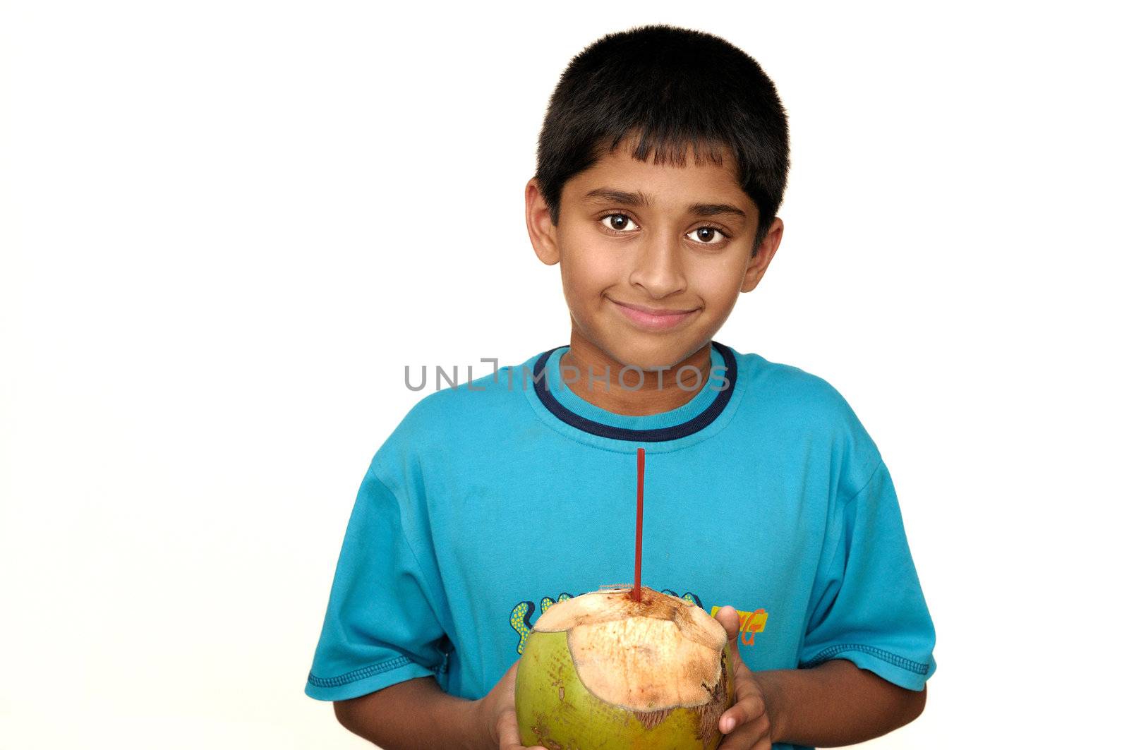 Ajn handsome Indian kid drinking coconut water to cool off