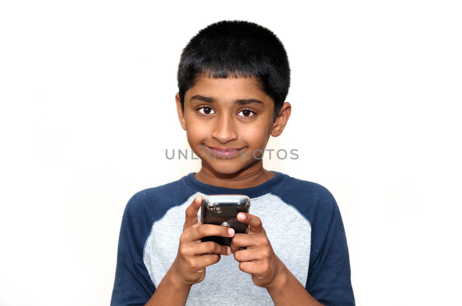 An handsome Indian kid playing games with teh cell phone