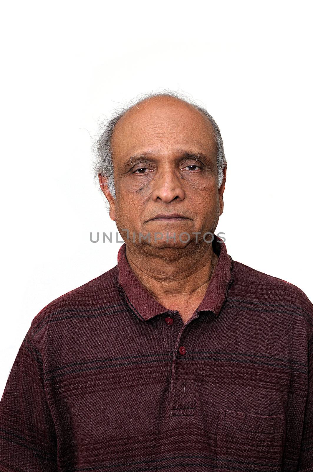 an old indian senior loking very sad about his retirement