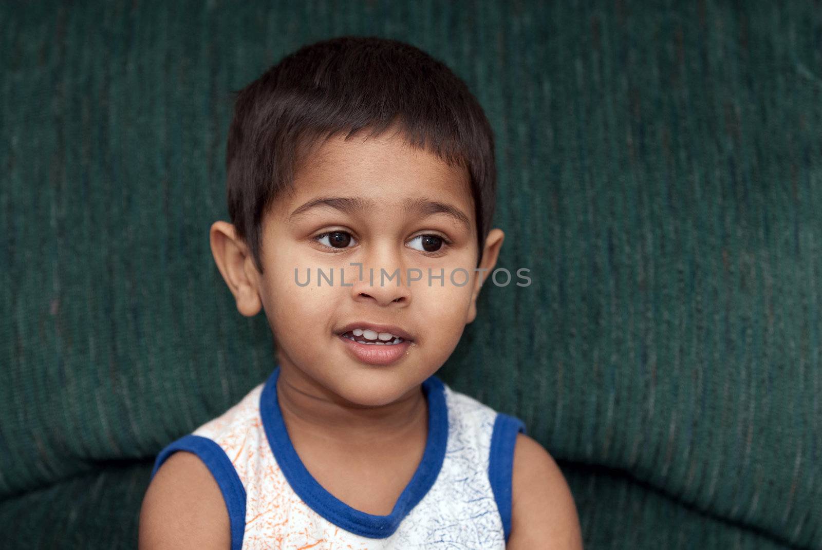 handsome indian kid smiling in front of the camera