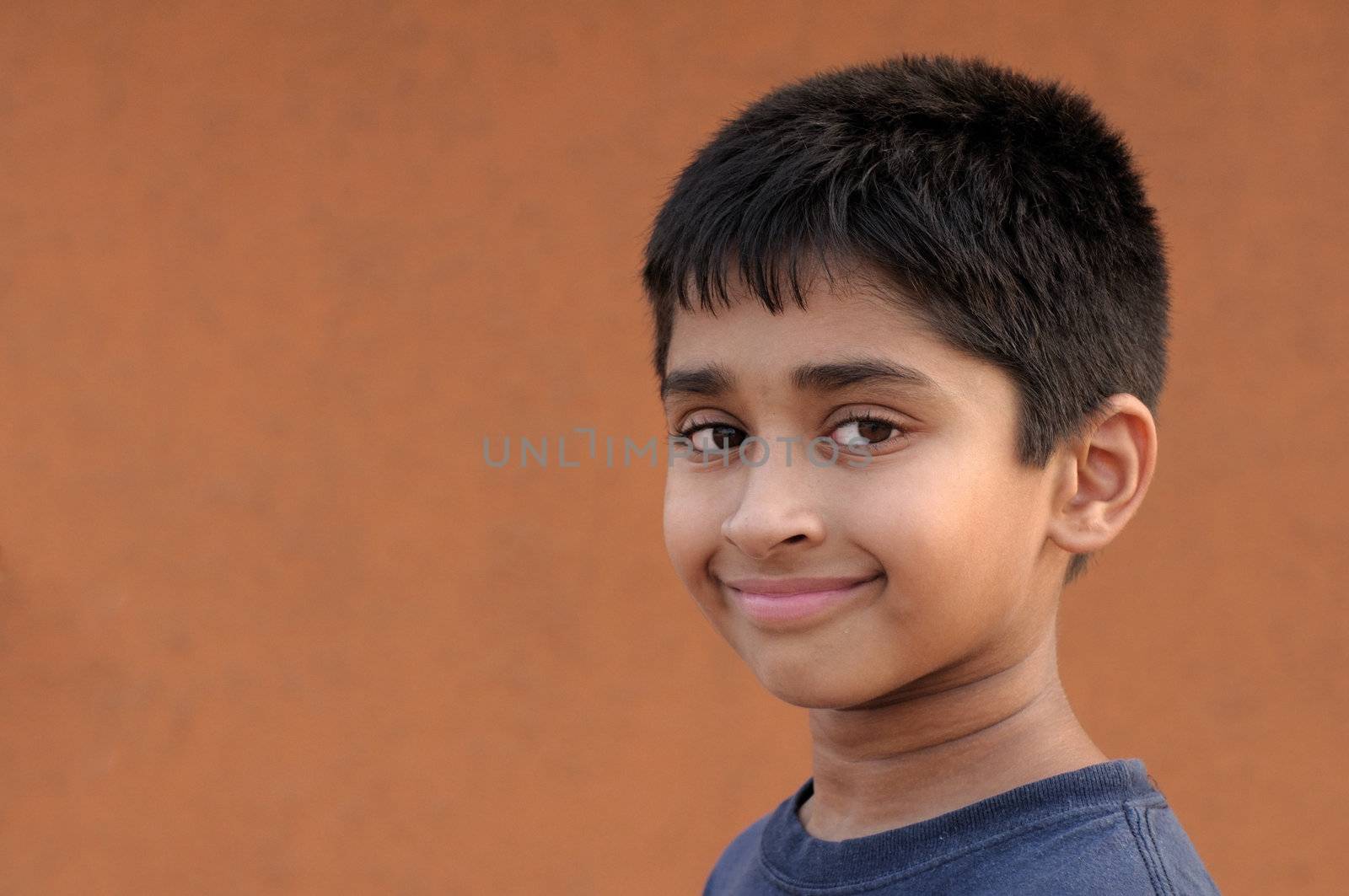 Handsome Indian kid smiling in front of the camera