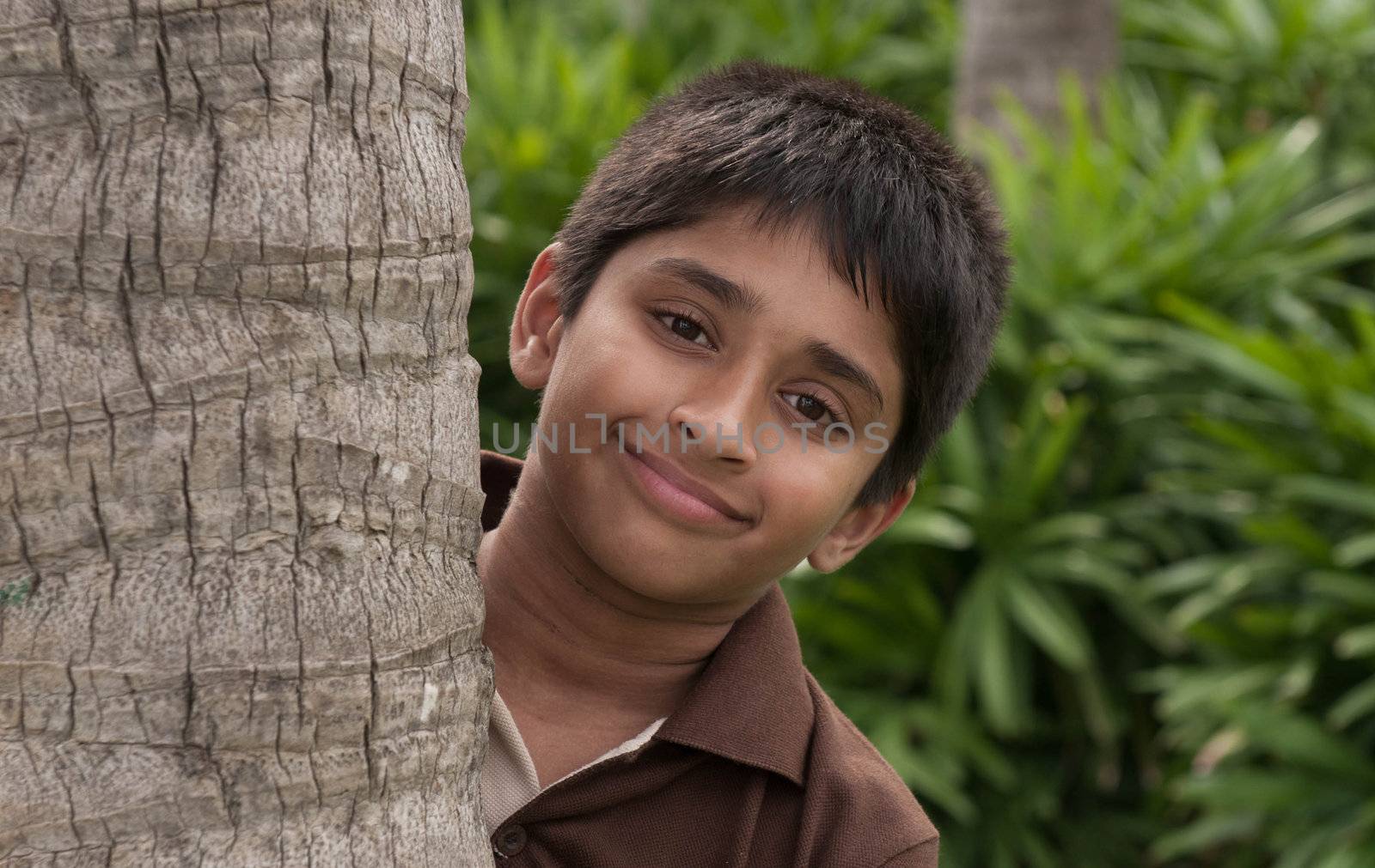 An handsome Indian kid peeping thru the trunk