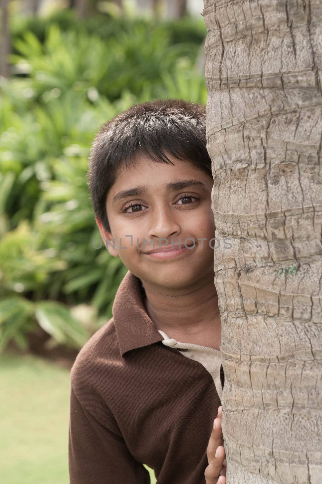 An handsome Indian kid peeping thru the trunk