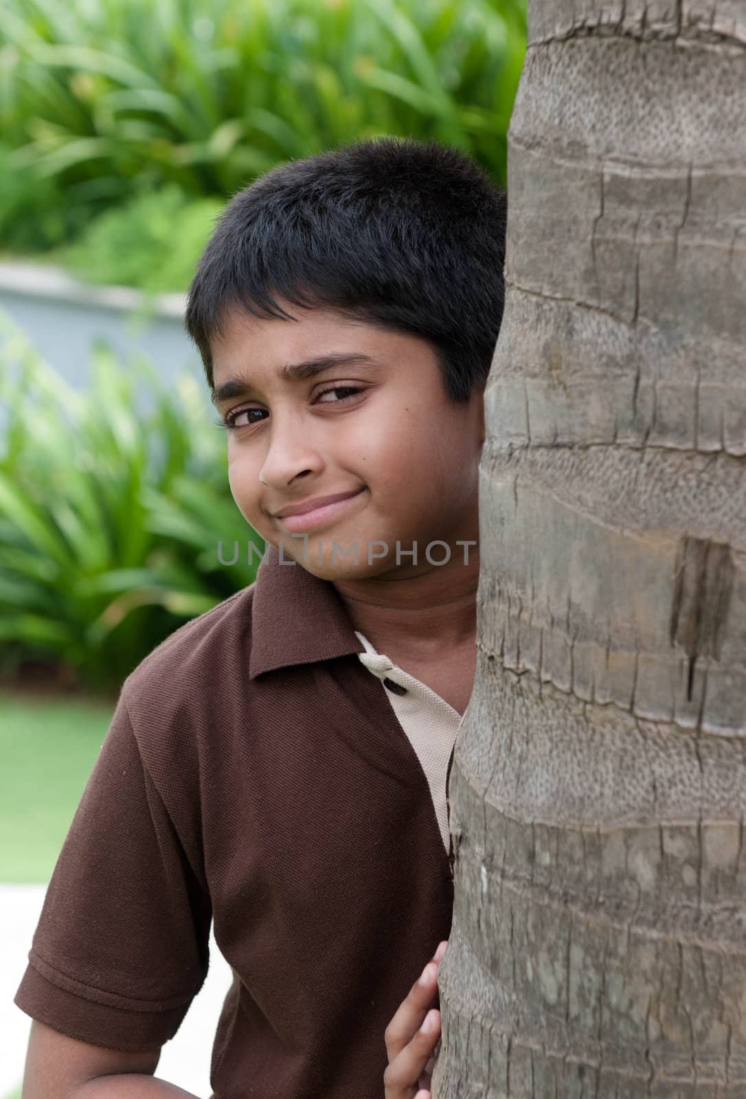 An handsome Indian kid peeping thru the trunk