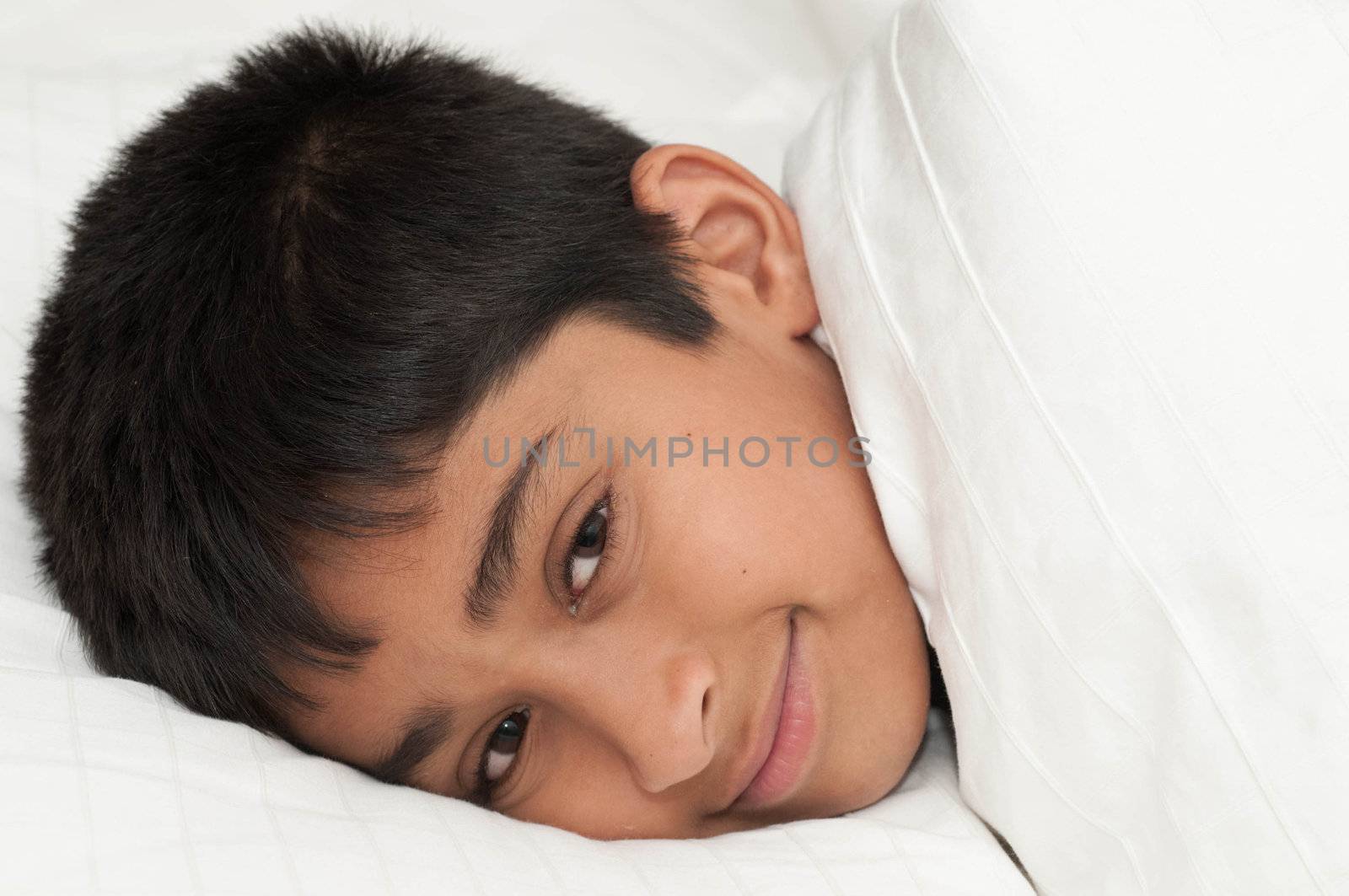 A handsome indian kid smiling for you