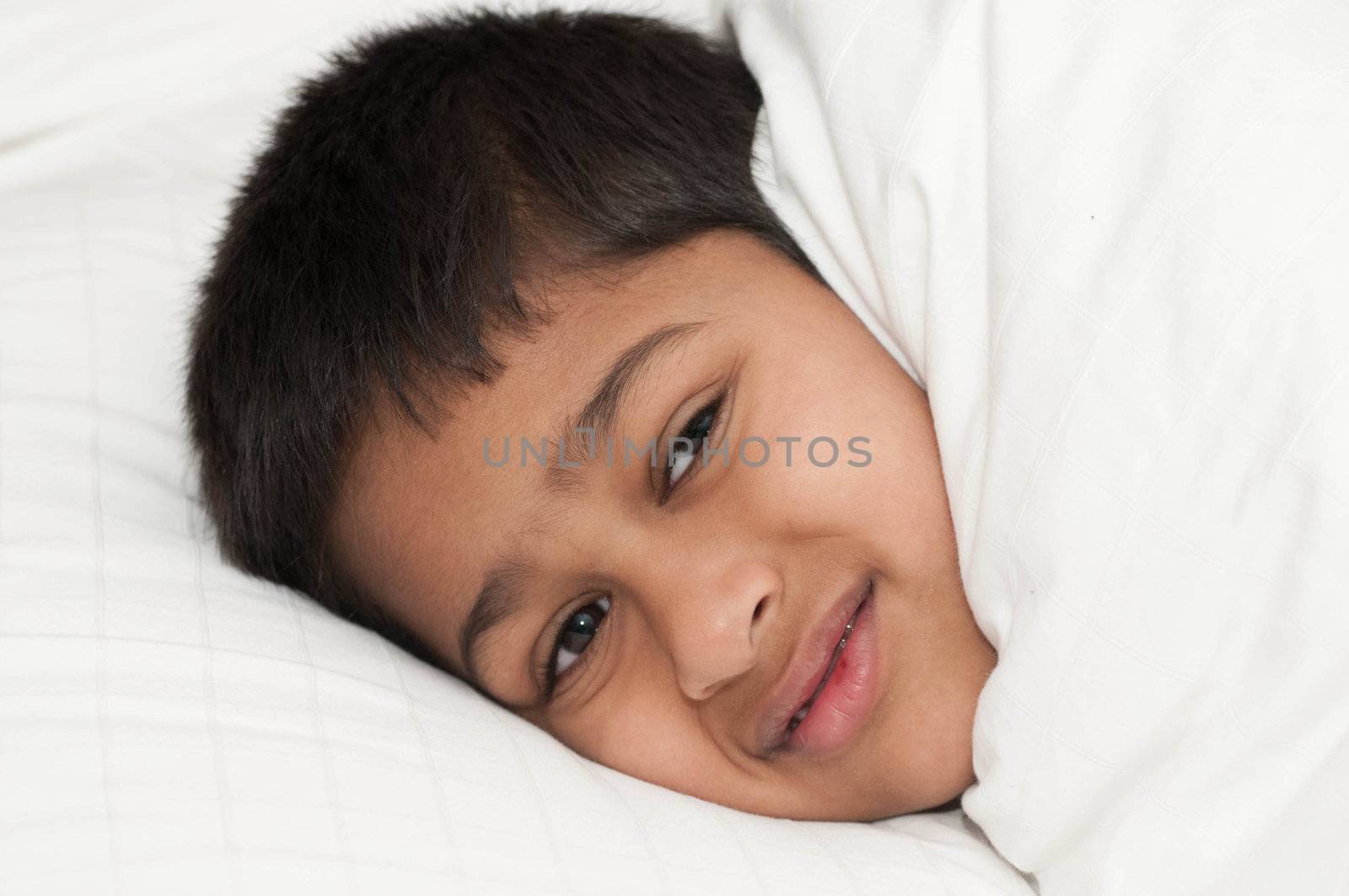 A handsome indian kid smiling for you