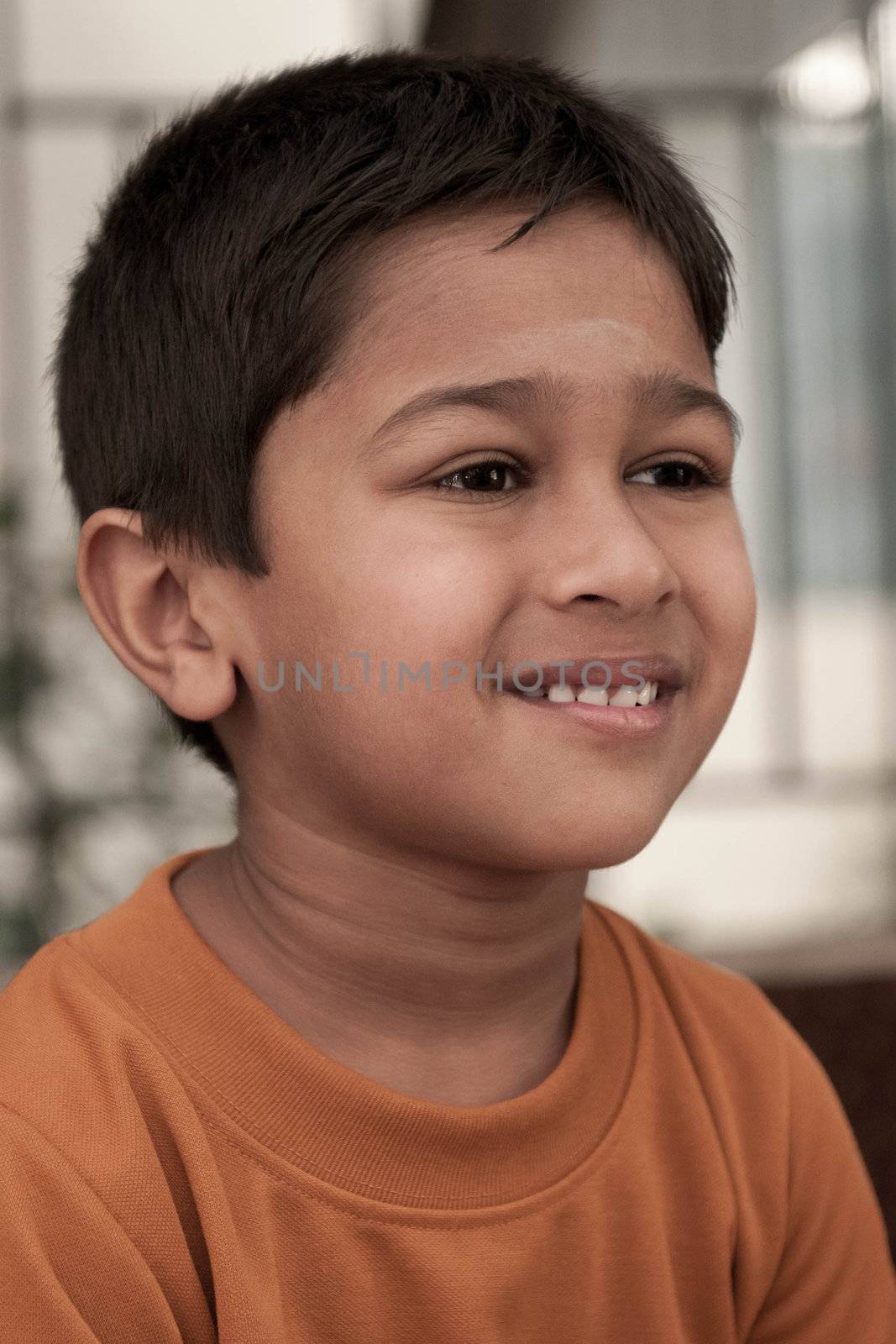 Handsome Indian kid smirking in front of the camera