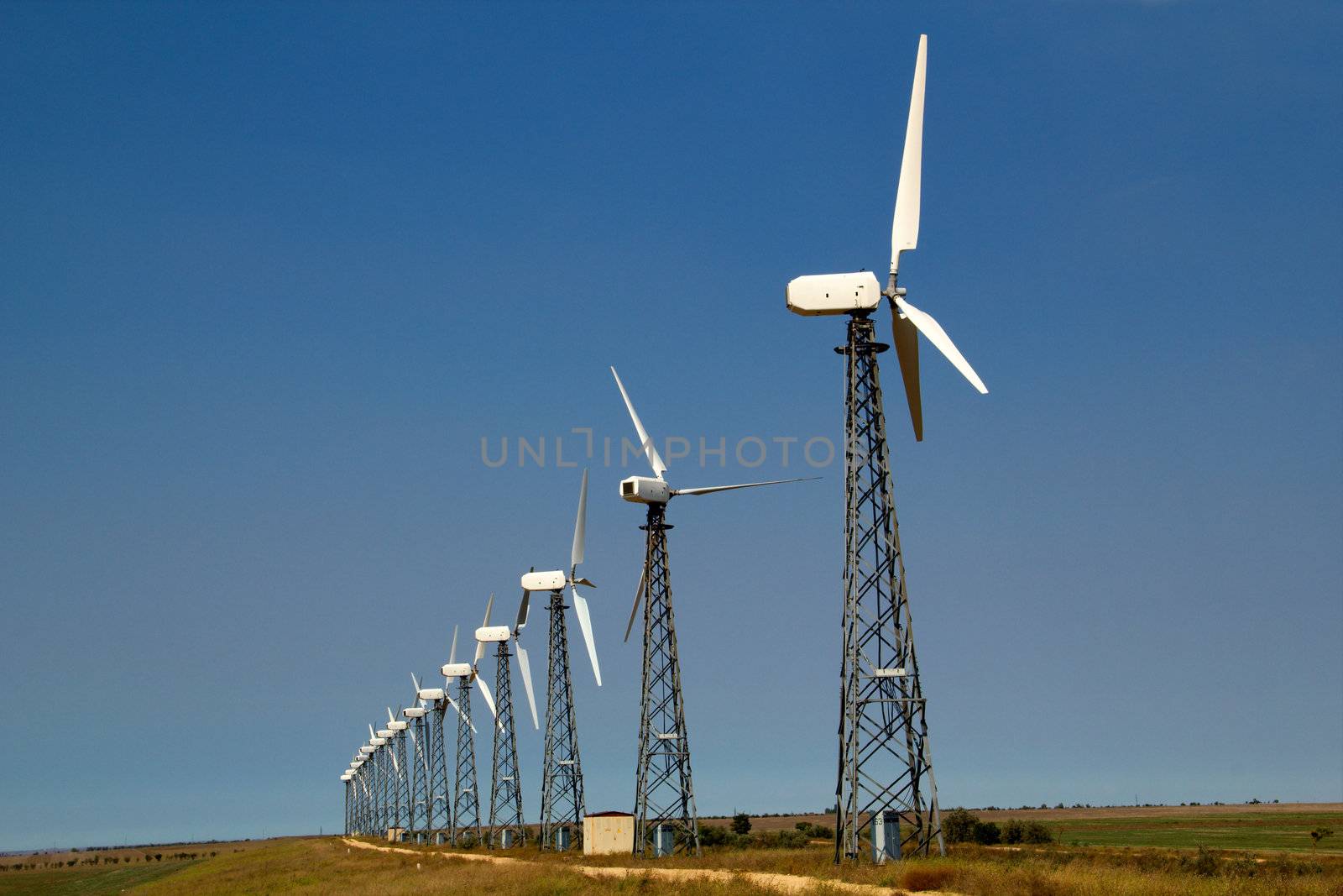 The wind generators against the blue sky