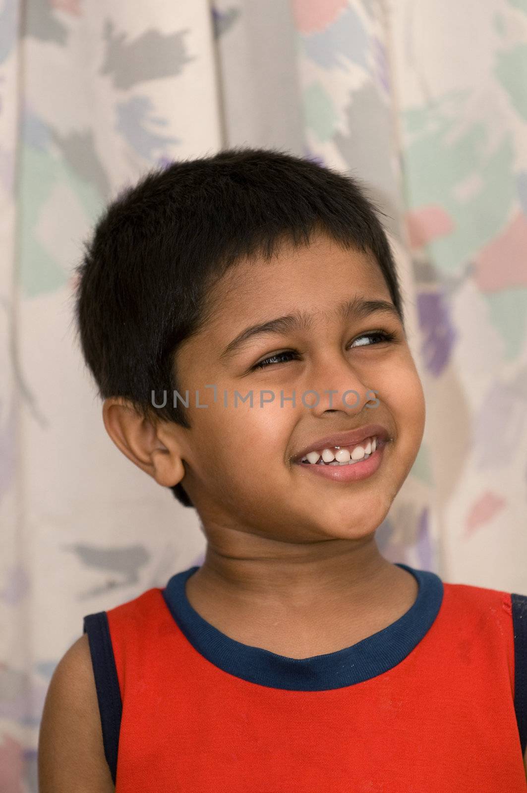 an handsome indian kid looking very thoughtful by pazham