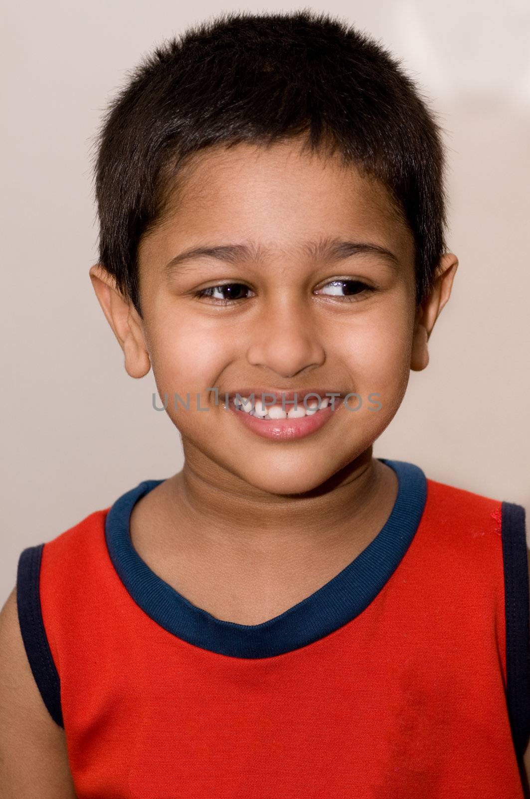 An handsome Indian kid smiling by pazham