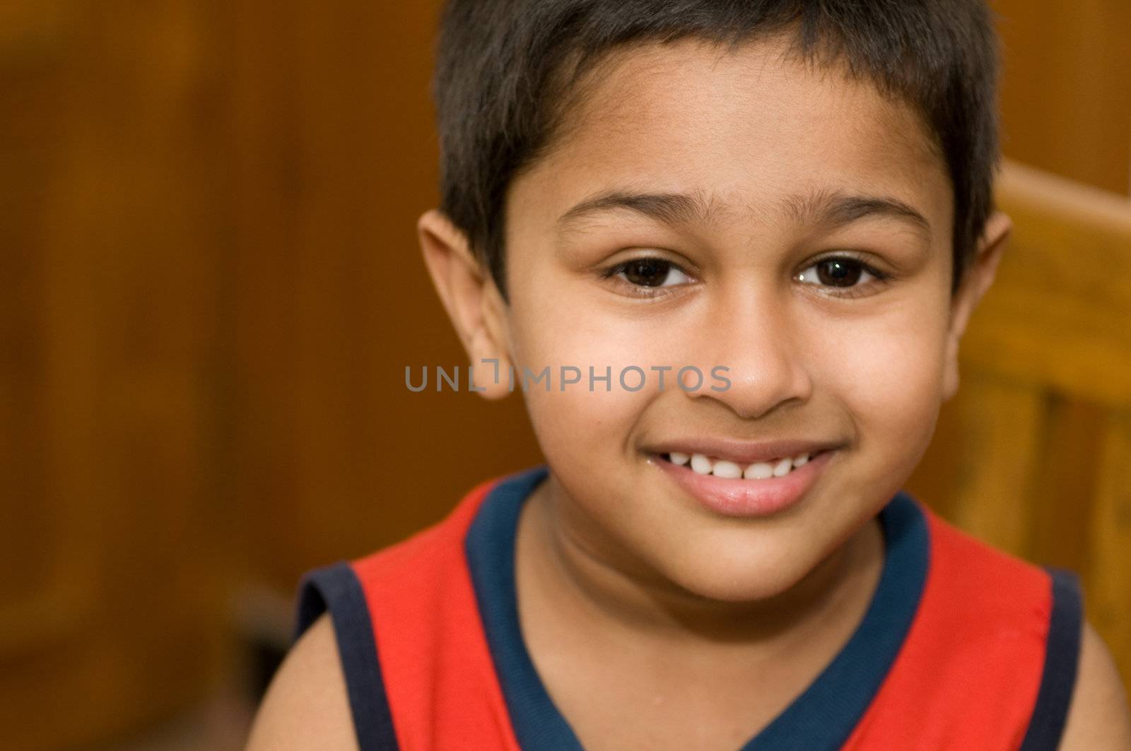 An handsome Indian kid smiling by pazham