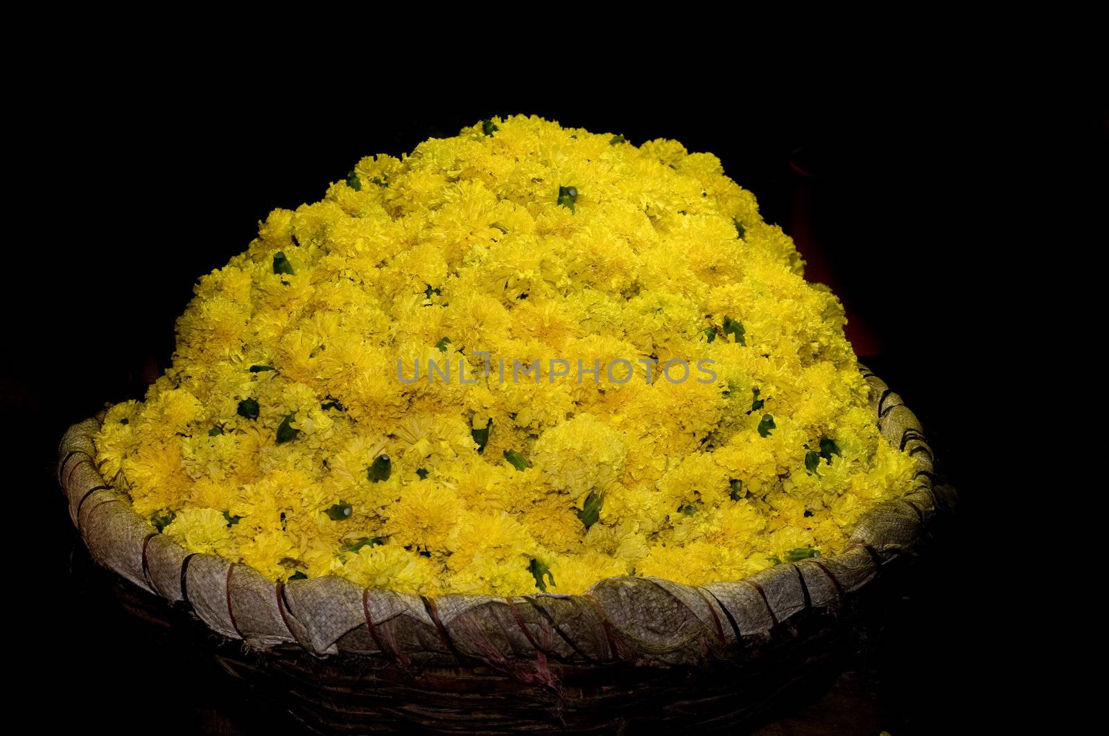 basket full of yellow flowers at a local flower market by pazham