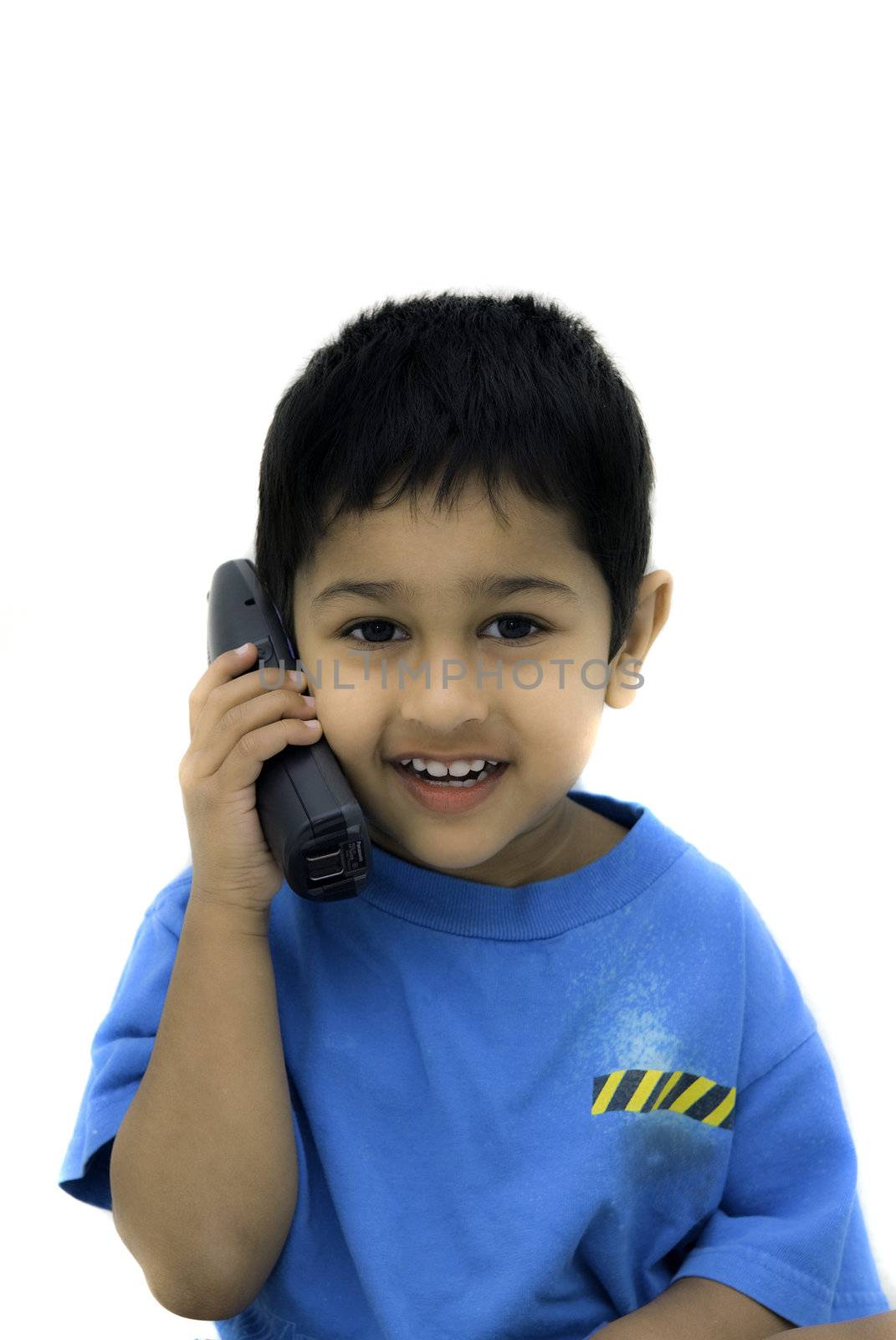 An handsome Indian kid alking happily on a phone