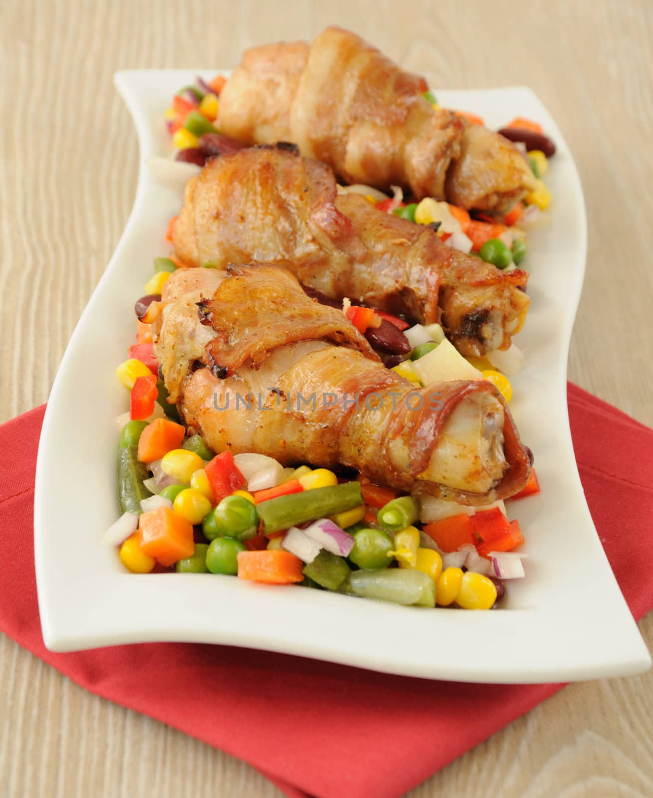  chicken leg wrapped in bacon with vegetables by Apolonia